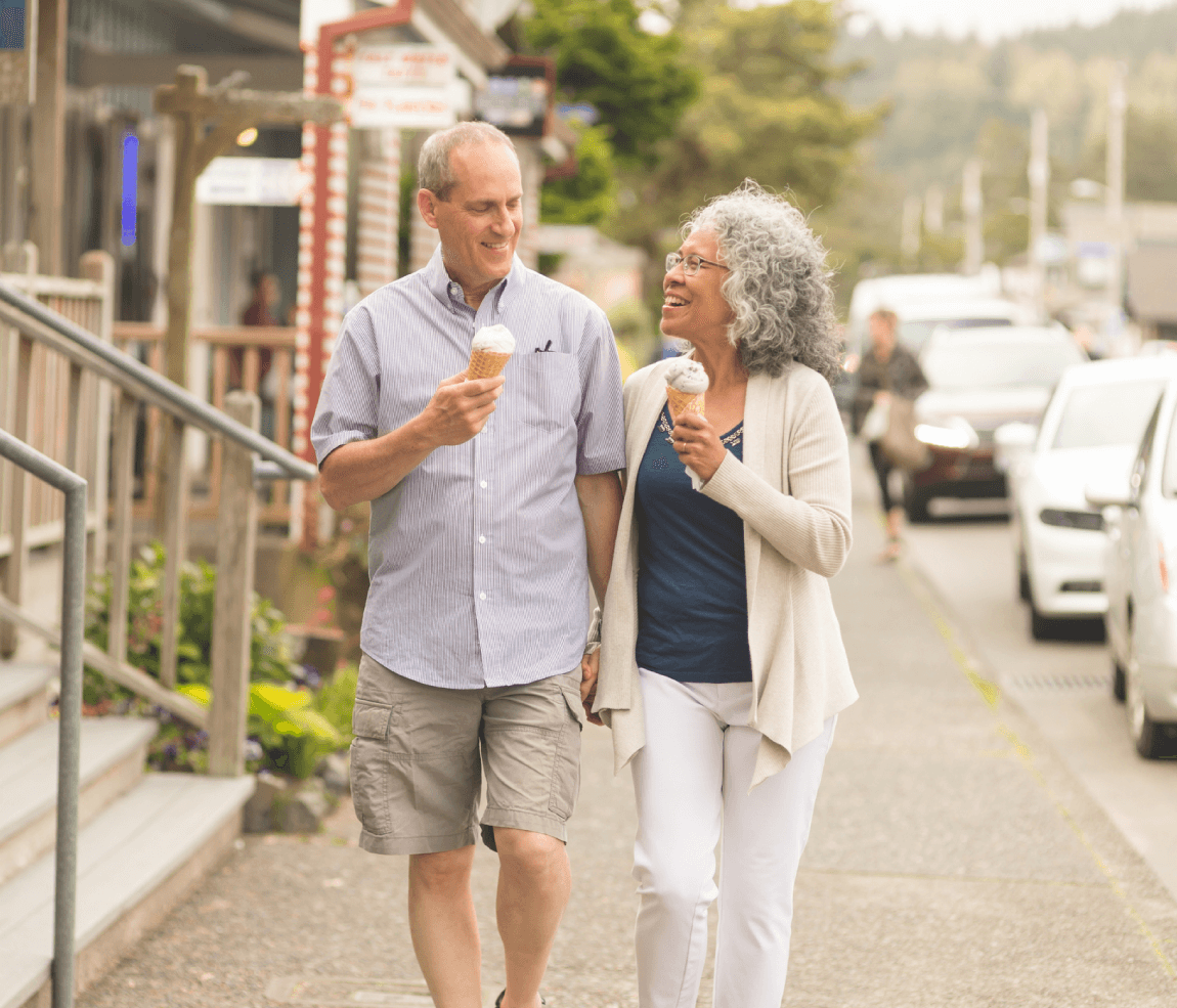Senior couple walking down the street eating ice cream