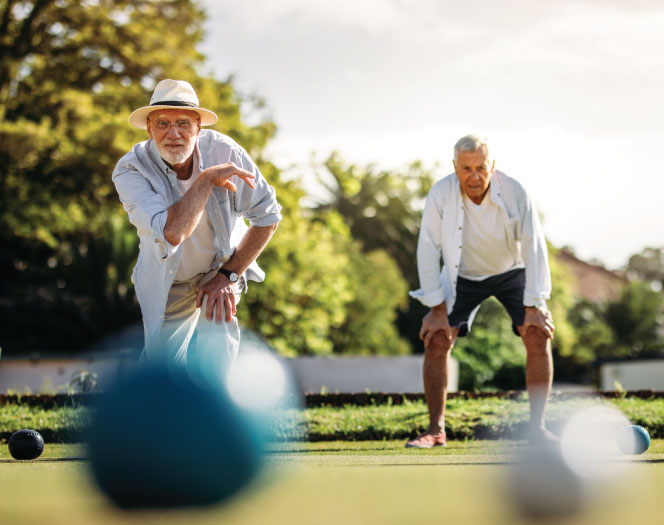 two senior men playing bocce ball