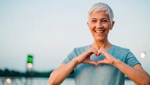 Senior woman making a heart with her hands