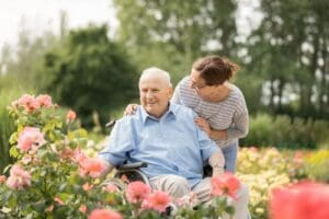 Senior man enjoying flowers in a garden