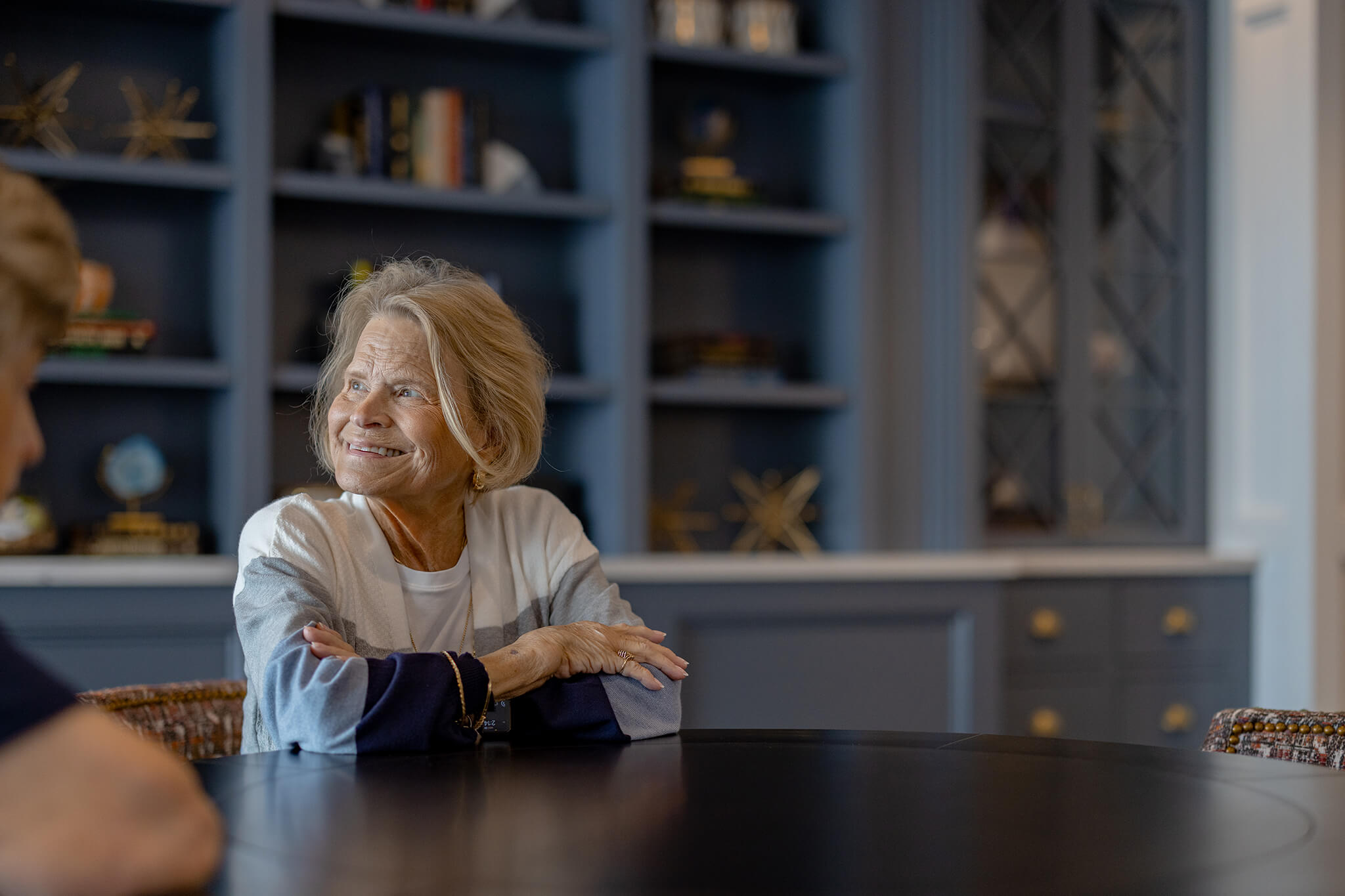 senior woman in assisted living sitting at a table