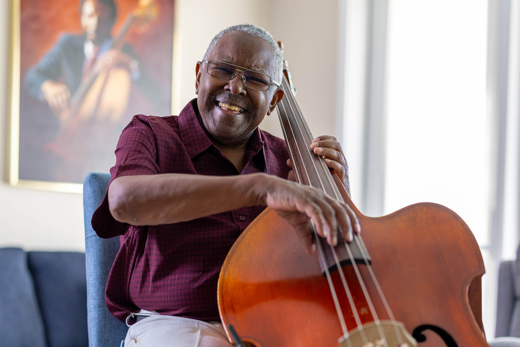 senior man playing bass