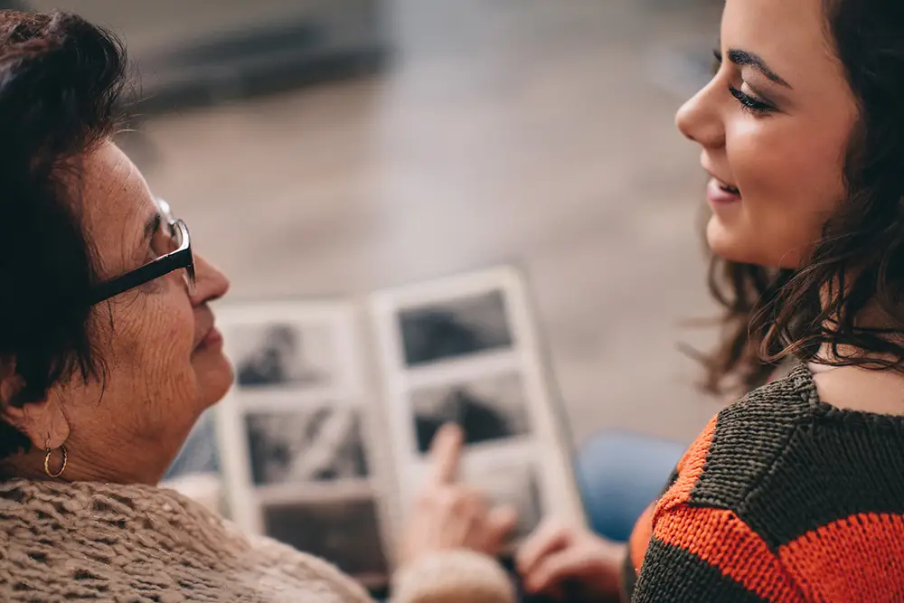 Mother and daughter looking at family photos