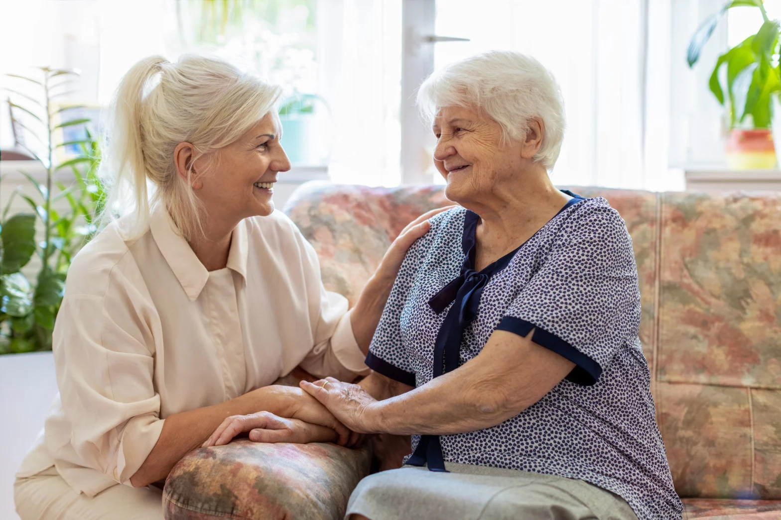senior mother sitting with her daughter to talk about a memory care checklist at The Delaney at The Green.