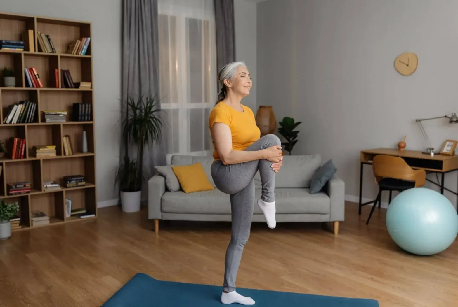 A senior woman stretching and doing mobility exercises for seniors to help improve independence.